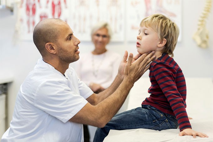 Doctor/nurse examining a child